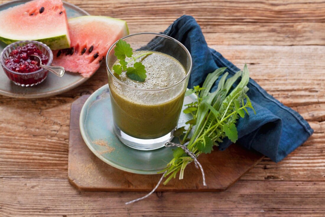 A watermelon smoothie made with pomegranate seeds, apples and meadow herbs