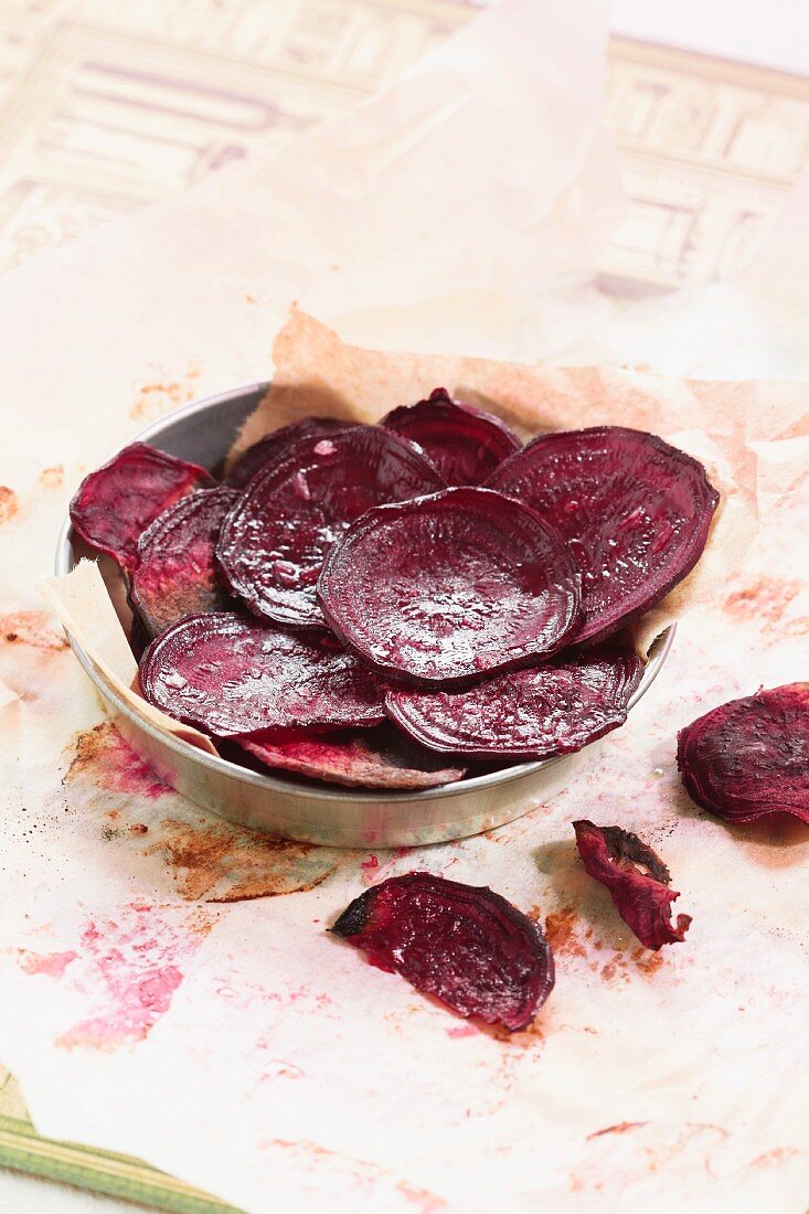 Beetroot crisps on a piece of baking paper