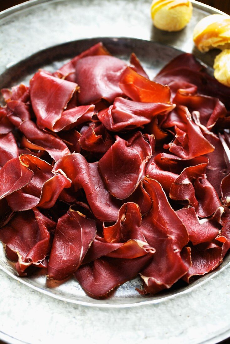 Smoked venison ham on a metal plate