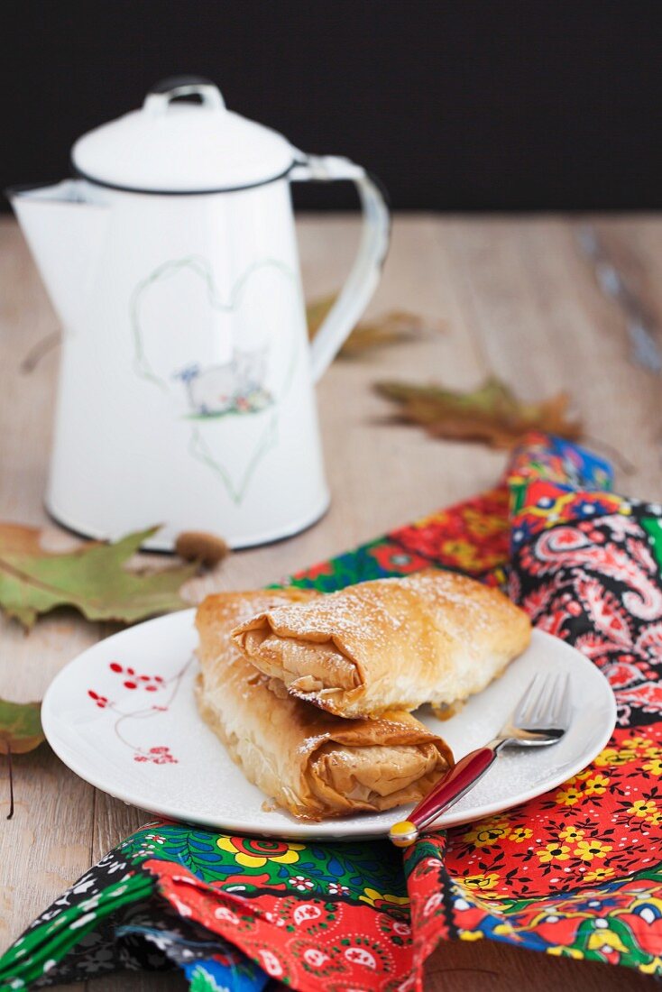 A mini apple and pumpkin strudel served with coffee