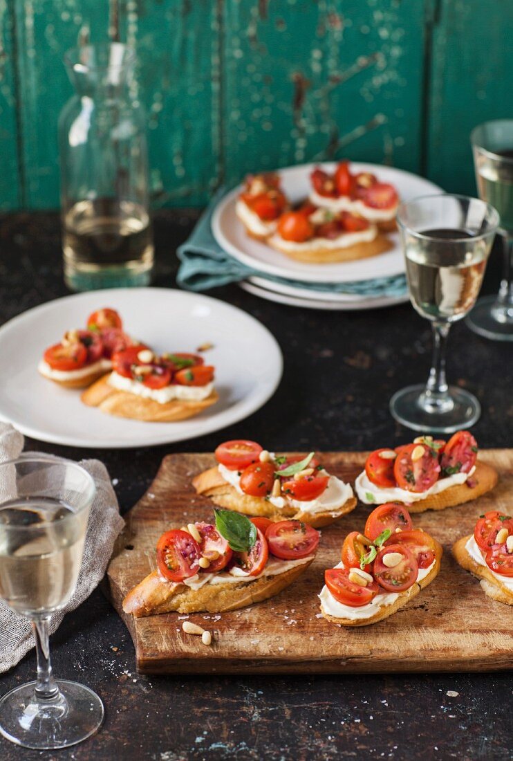 Bruschetta with tomatoes, whipped goat cheese and pine nuts