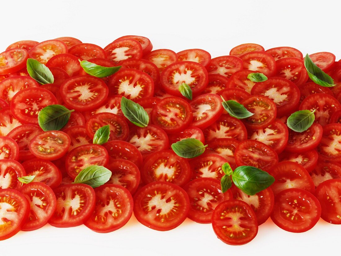 Tomato slices and basil leaves