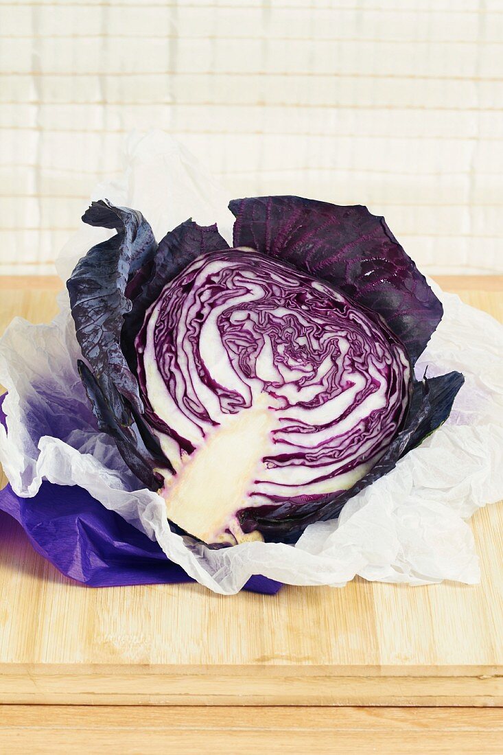 Half a red cabbage on a piece of white paper