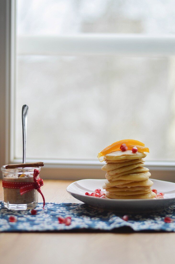 A stack of pancakes with pomegranate seeds for Christmas Day breakfast