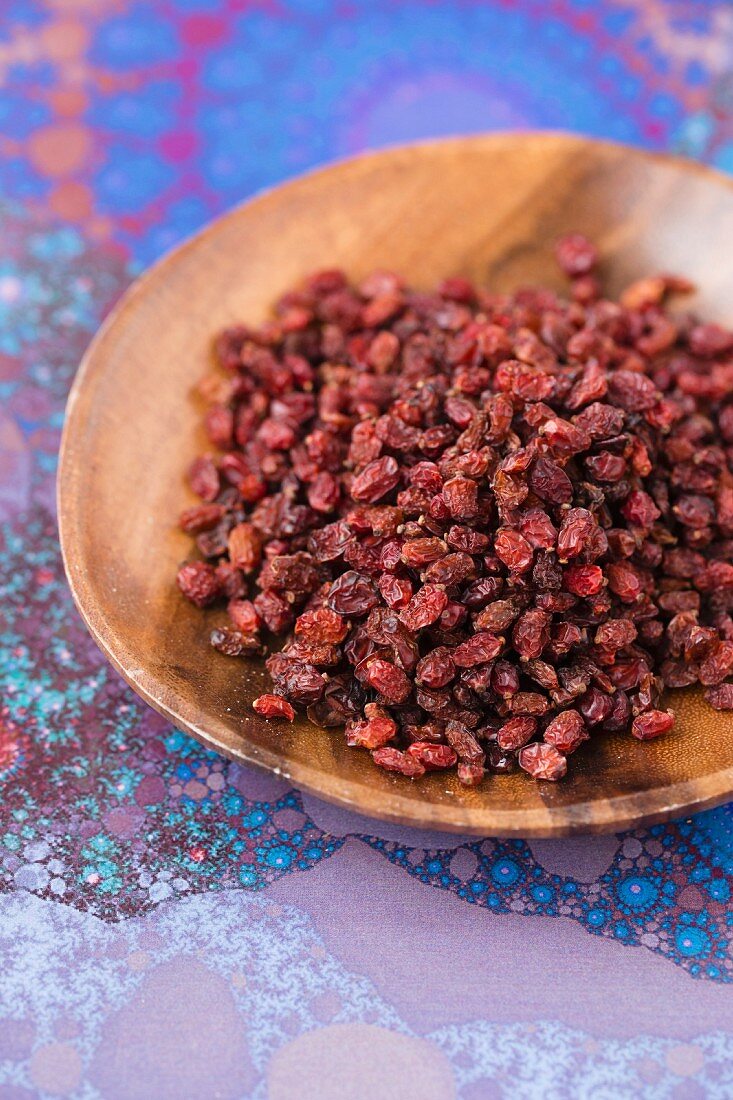 Barberries on a wooden plate, dried