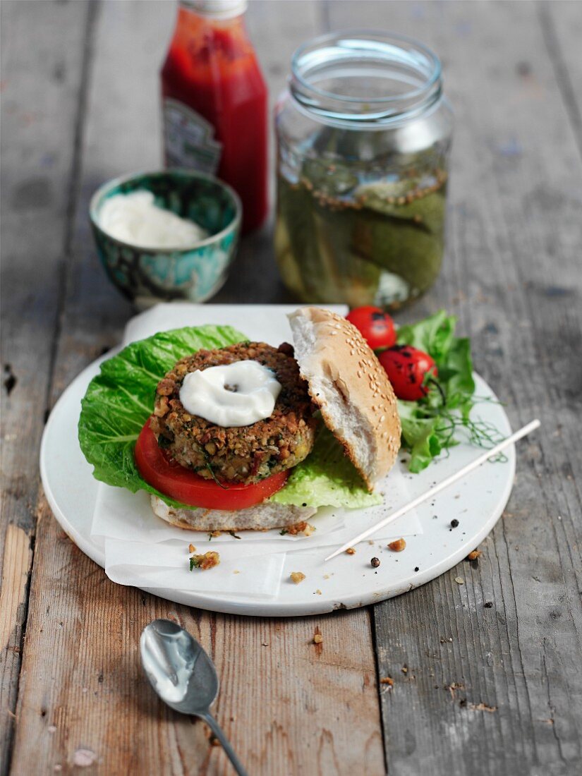 A chickpea burger with yogurt and gherkins