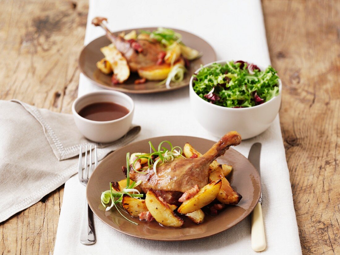 Duck confit with roast potatoes and salad