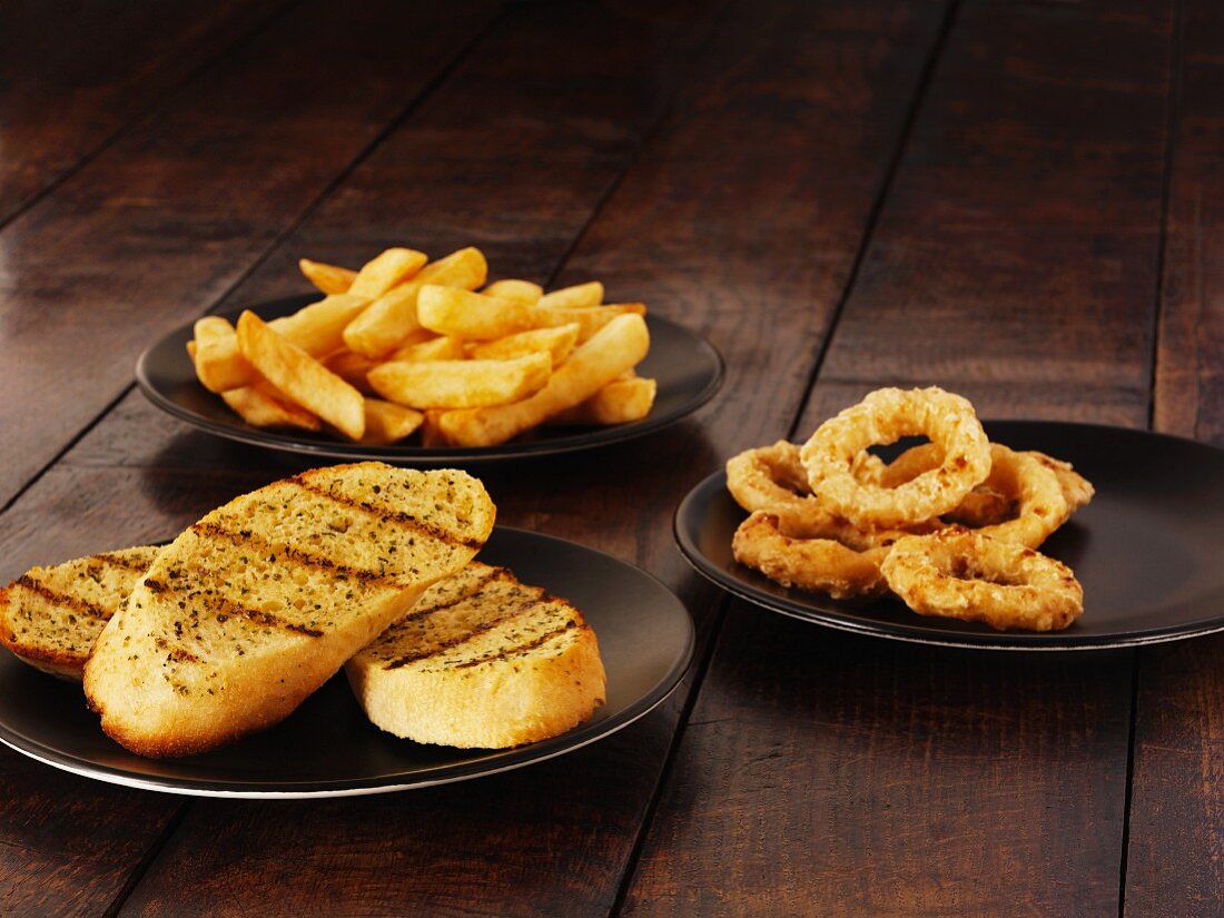 Garlic bread, onion rings and chips