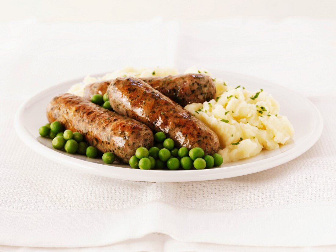 Pork and herb sausages with mashed potatoes and peas
