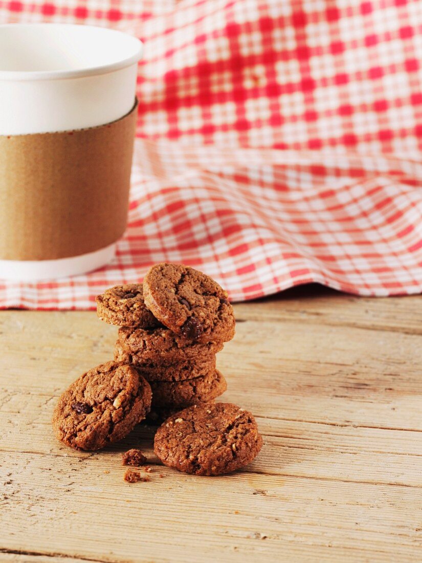 Chocolate chip cookies in front of a coffee cup