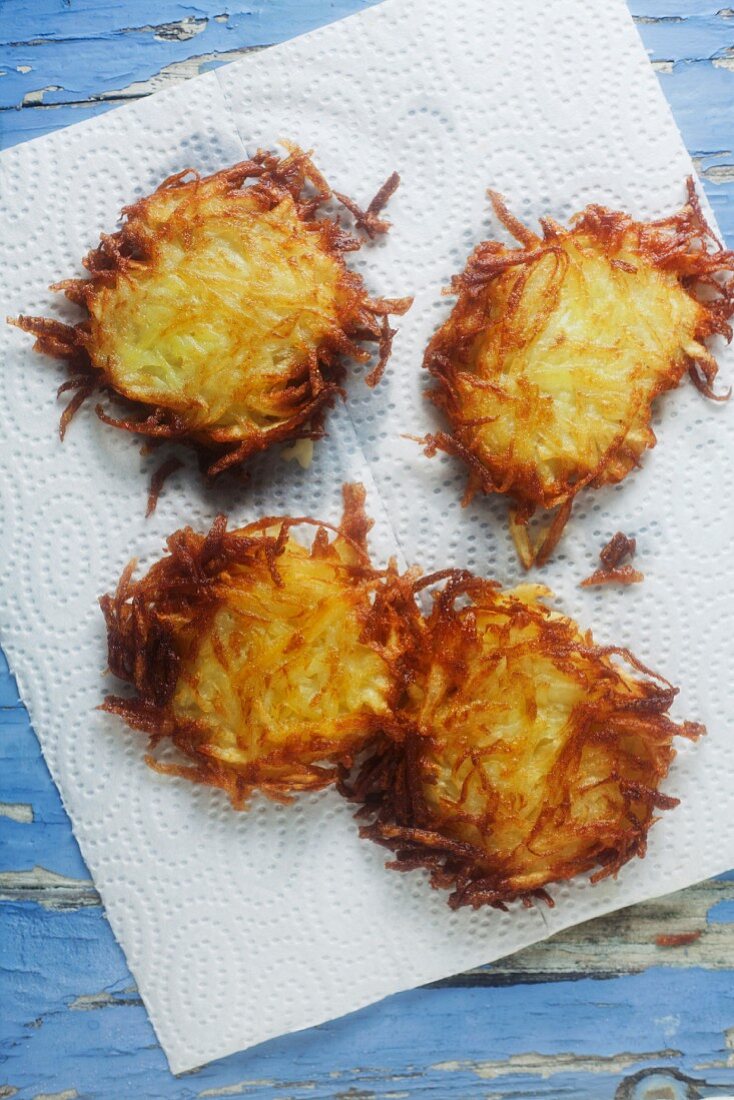 Crispy fried potato cakes on kitchen paper