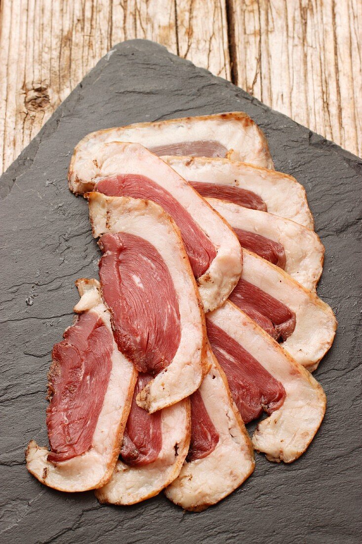 Air-dried goose breast on a slate platter