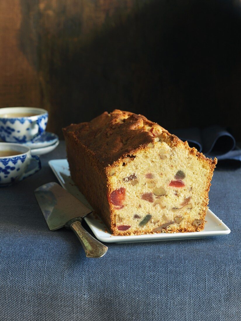 Sliced fruit and nut cake served with tea