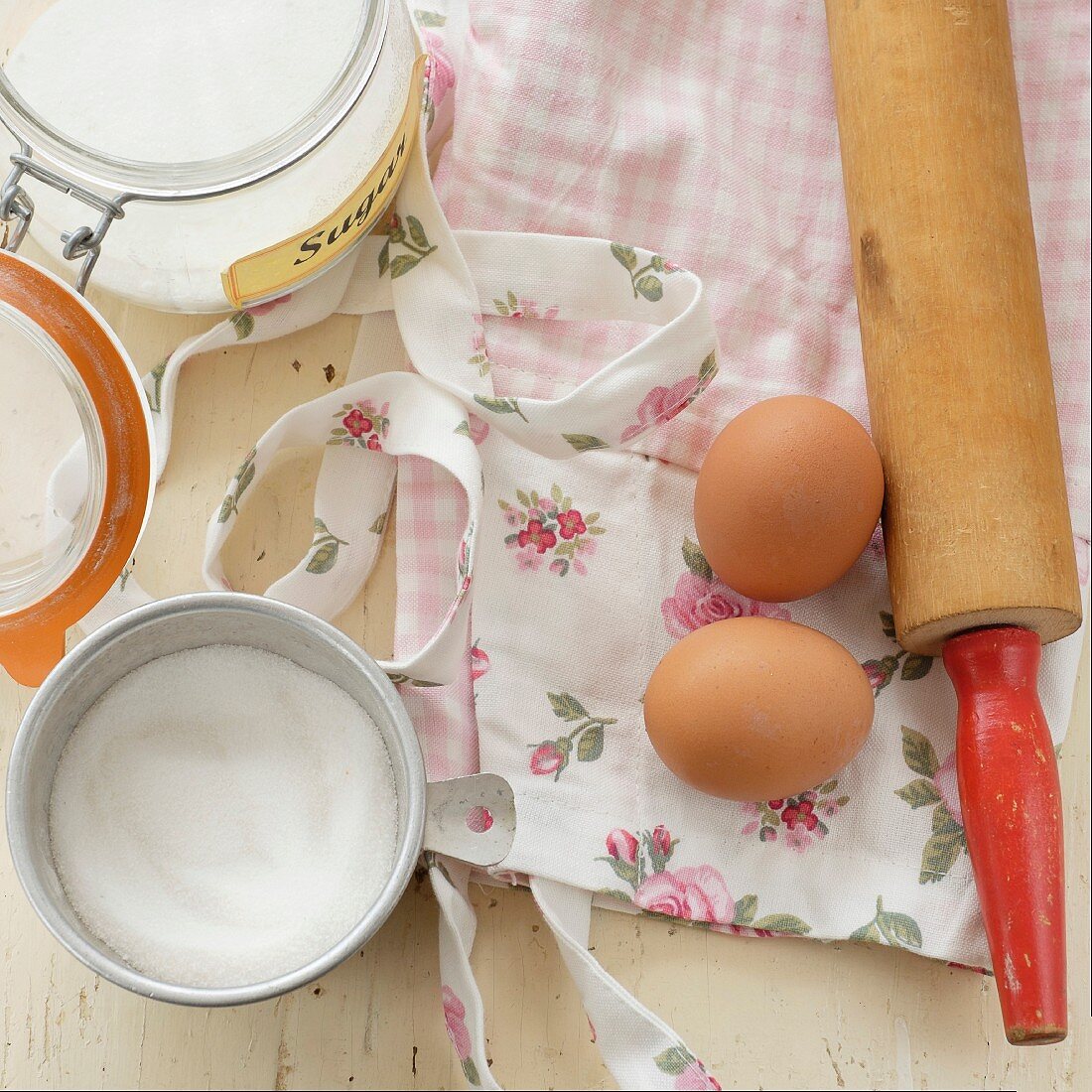 Baking ingredients and a rose-patterned apron