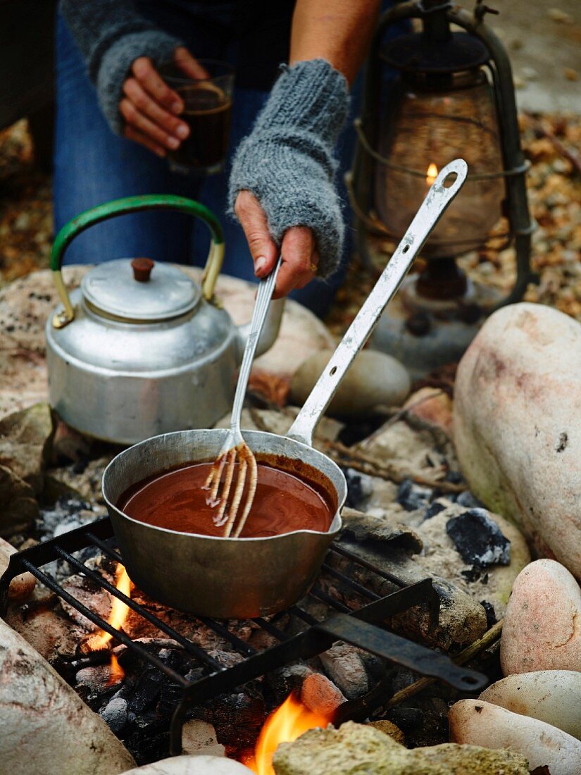 Bicerin (chocolate and coffee drink, Turin) in a saucepan over a coal fire