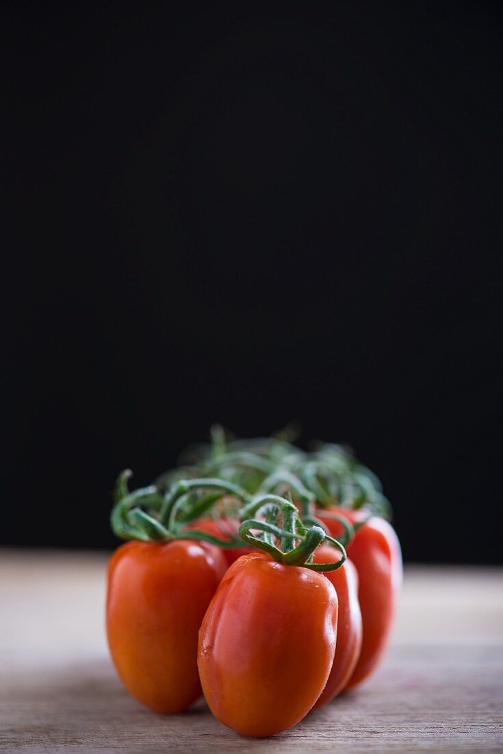 Vine tomatoes on a wooden surface