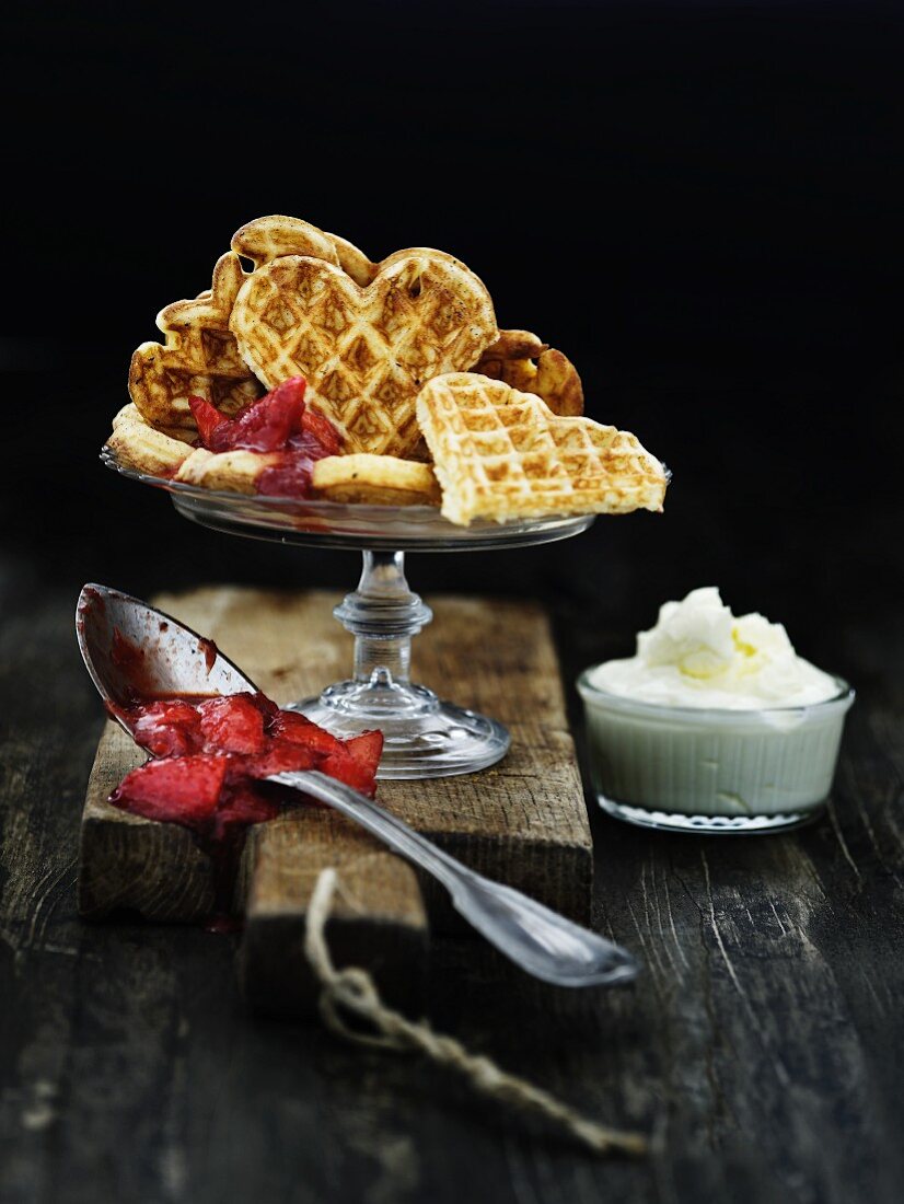 Heart waffles with strawberry jam and whipped cream