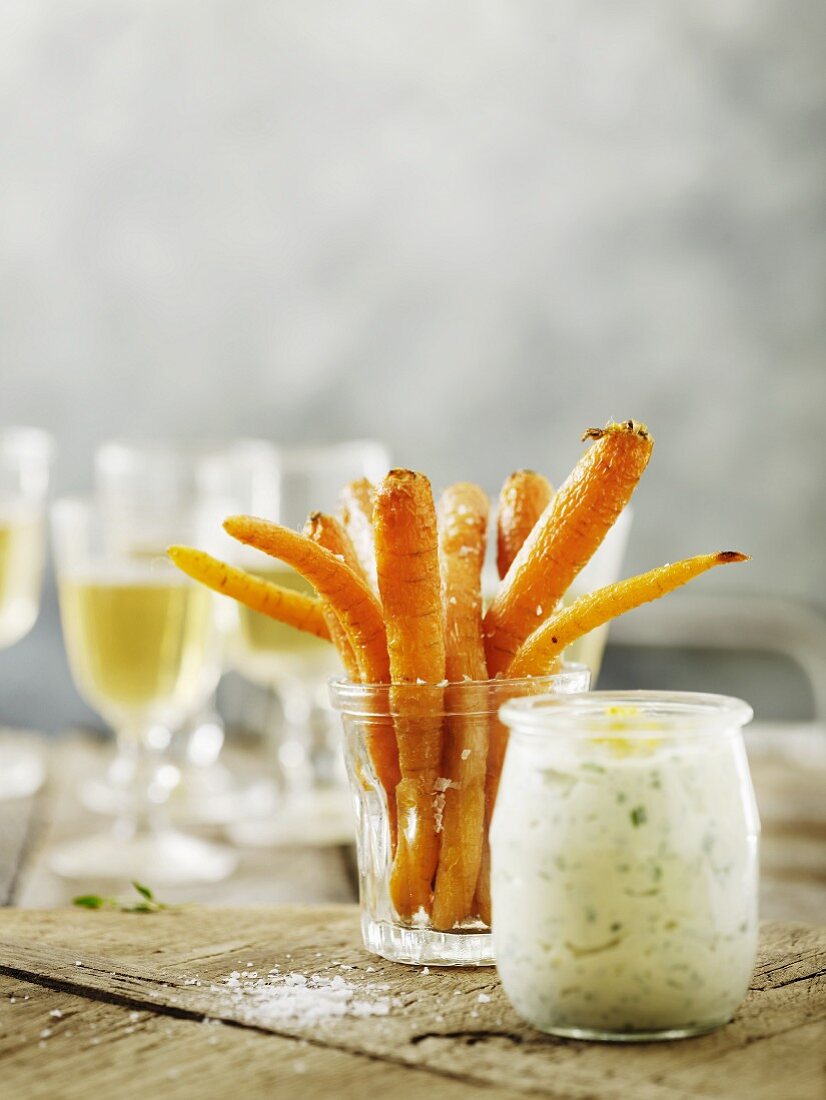 Roasted carrots in a glass with a dip