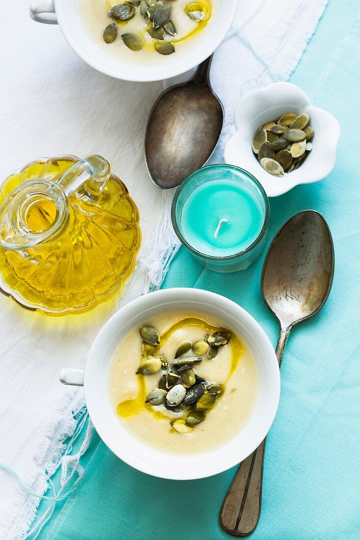 Patty pan squash soup with olive oil and pumpkin seeds