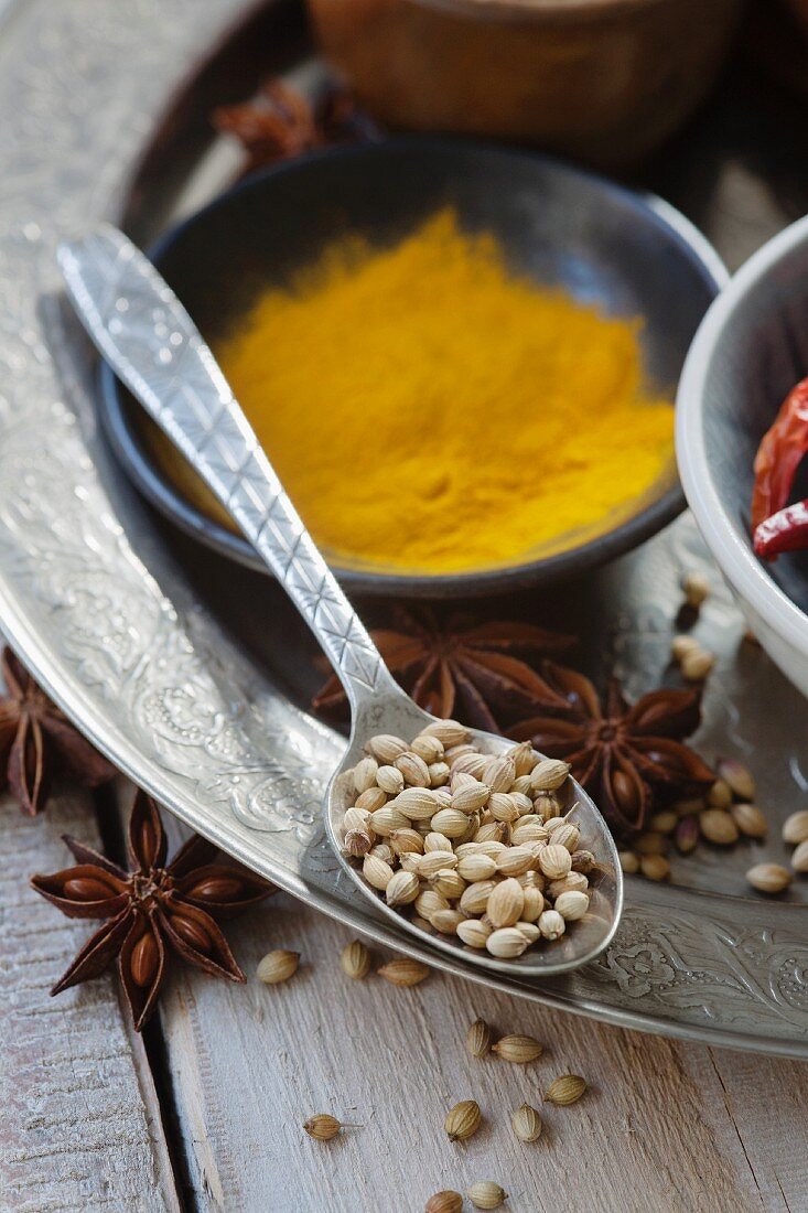 An arrangement of spices featuring coriander, star anise, chilli and turmeric