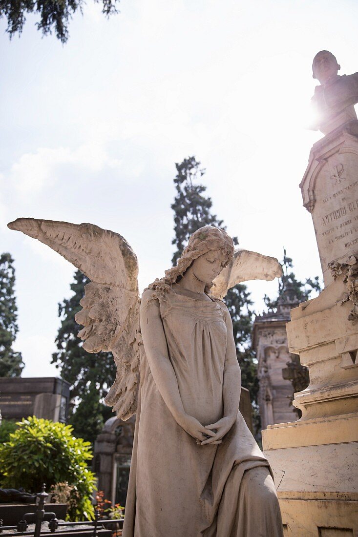 A stone angel standing guard at the Cimitero Monumentale, Milan