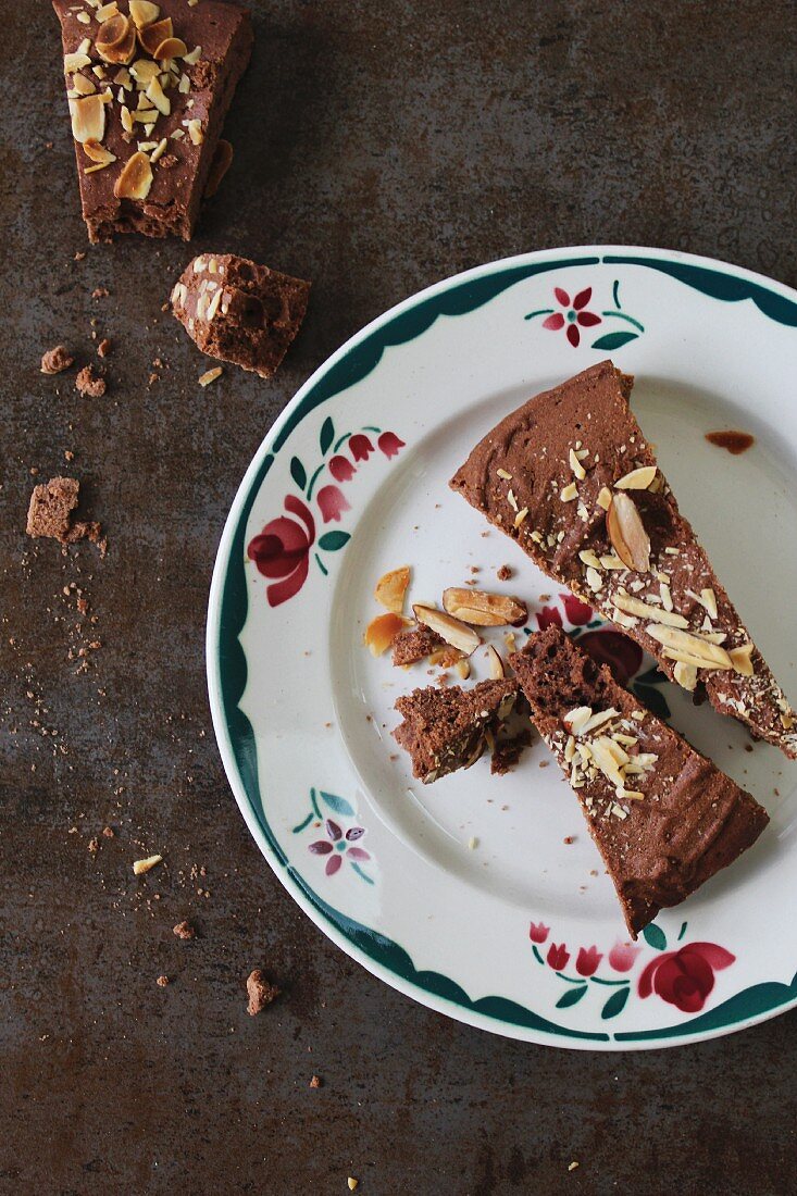 Slices of chocolate cake with almonds