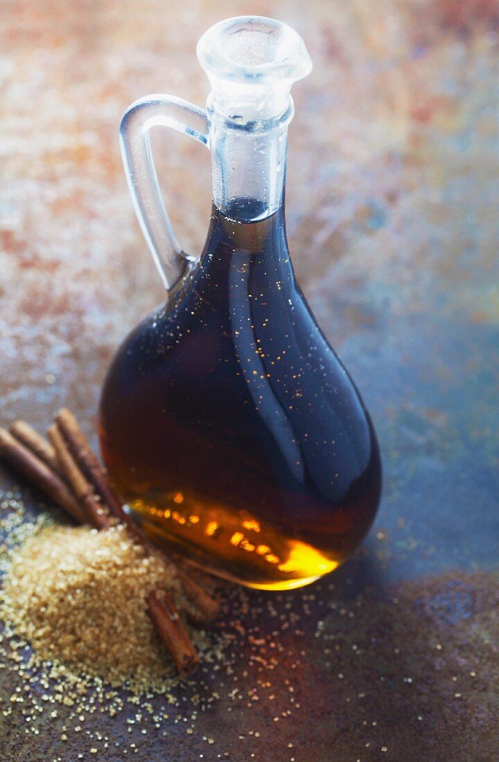 Cinnamon syrup in a bottle on a metal surface