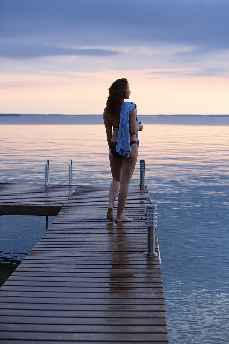 Woman wearing bikini on wooden jetty