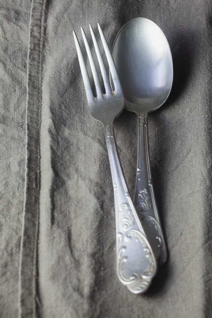 Silver cutlery on a linen napkin