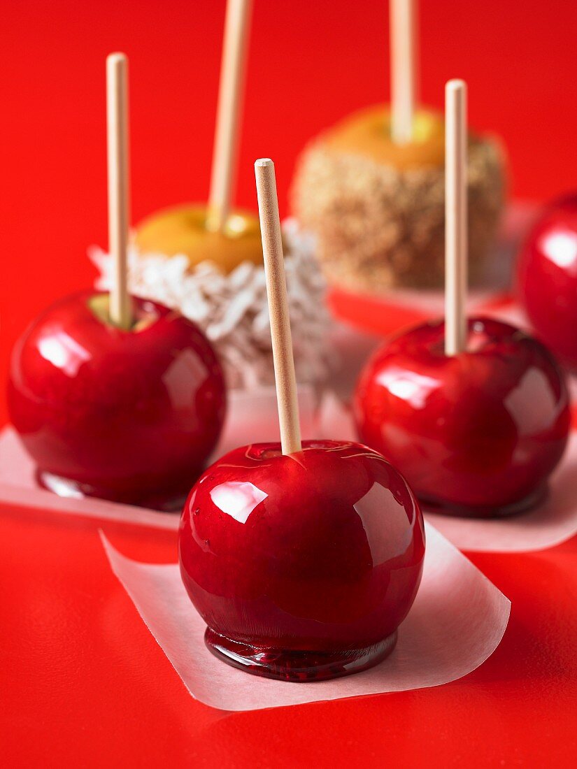 Toffee apples on pieces of paper