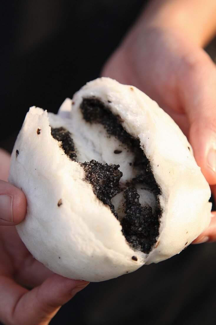 A steamed roll filled with black sesame paste