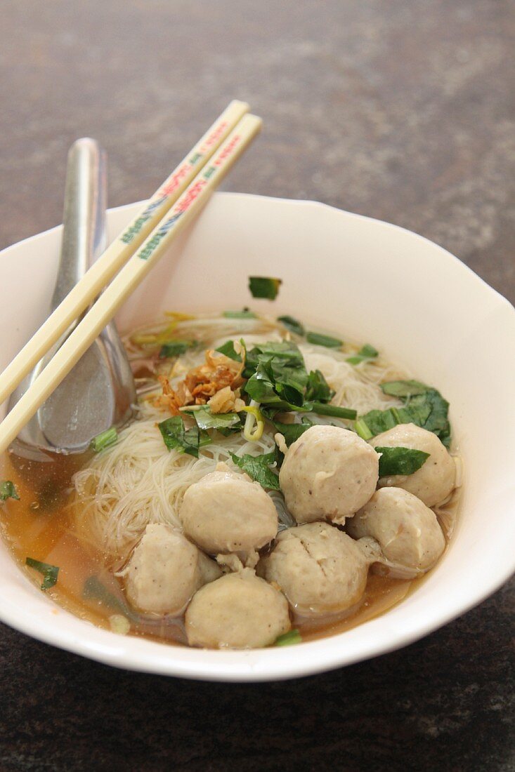 Noodle soup with meatballs and coriander