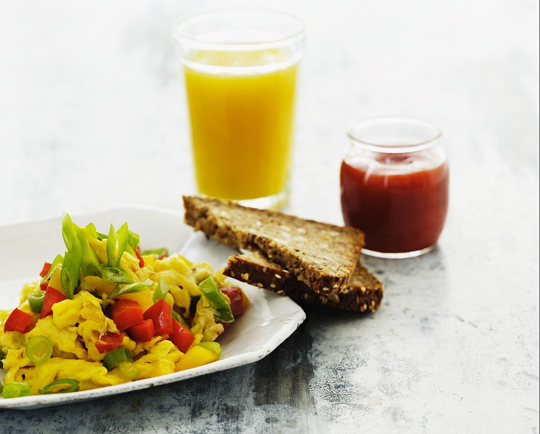 Scrambled eggs with vegetables, wholemeal bread and a glass or orange juice