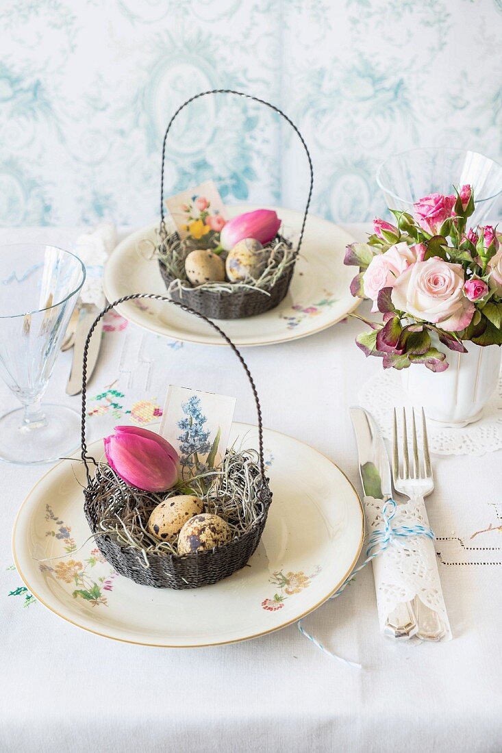 An Easter table decorated with bouquets and an Easter basket filled with eggs and a tulip