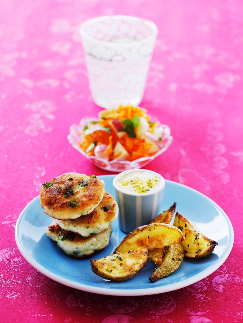 Fried fish cakes with potato wedges