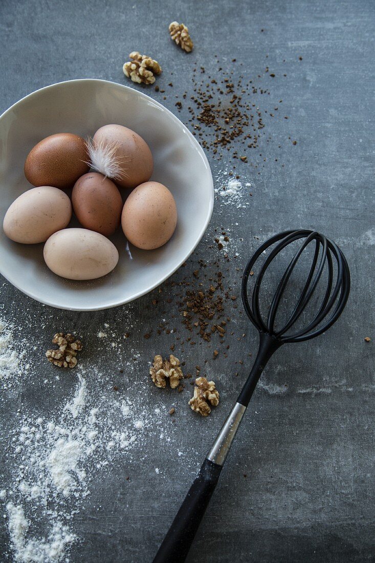 Fresh eggs, walnuts and a whisk