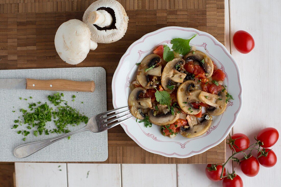Fried mushrooms and tomatoes with coriander