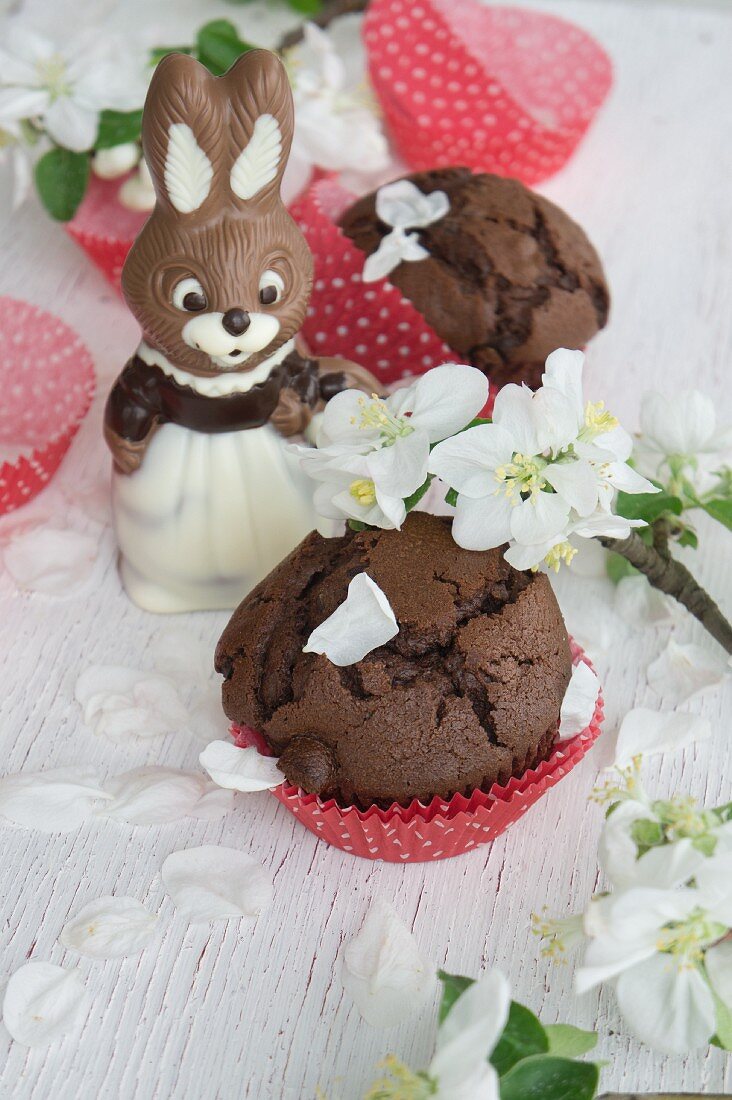 Chocolate muffins with a chocolate Easter bunny and apple blossom