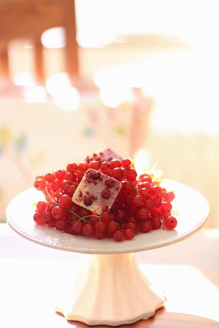 Fresh redcurrants on a white cake stand