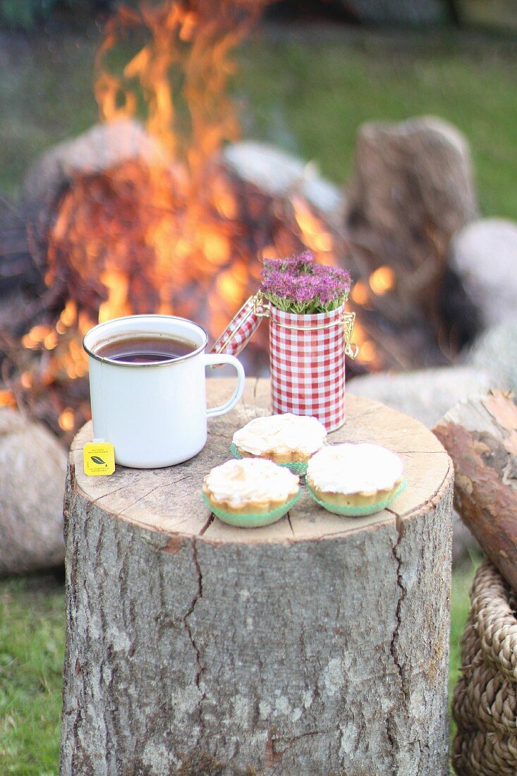 Muffins and tea by a campfire