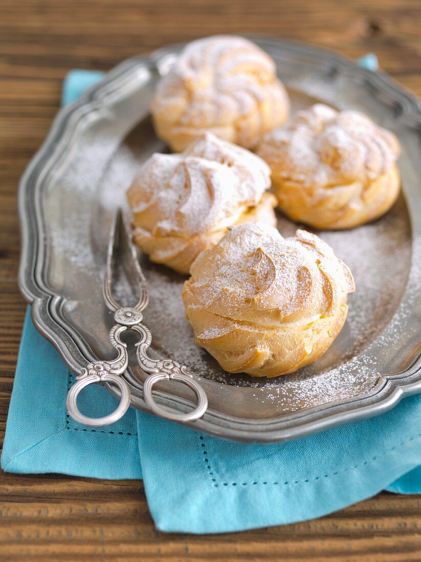 Profiterole with whipped cream and icing sugar