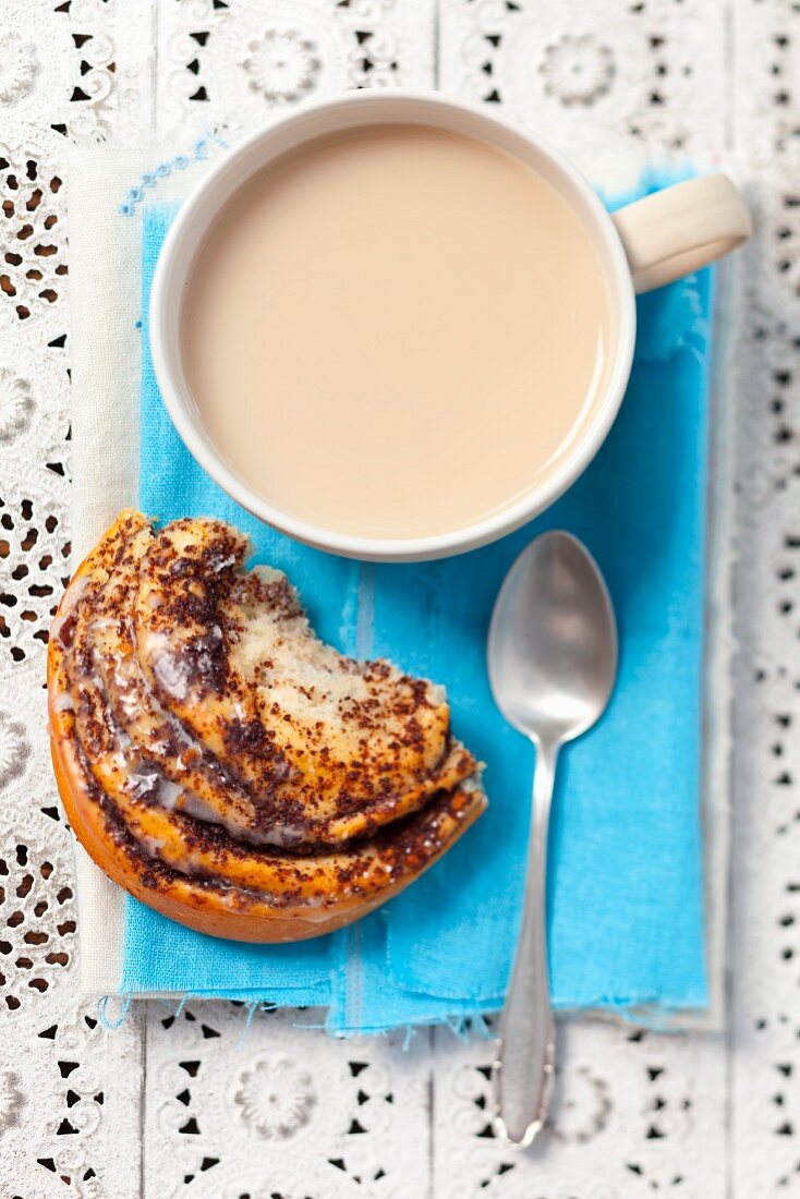 A poppyseed pastry with a cafe au lait