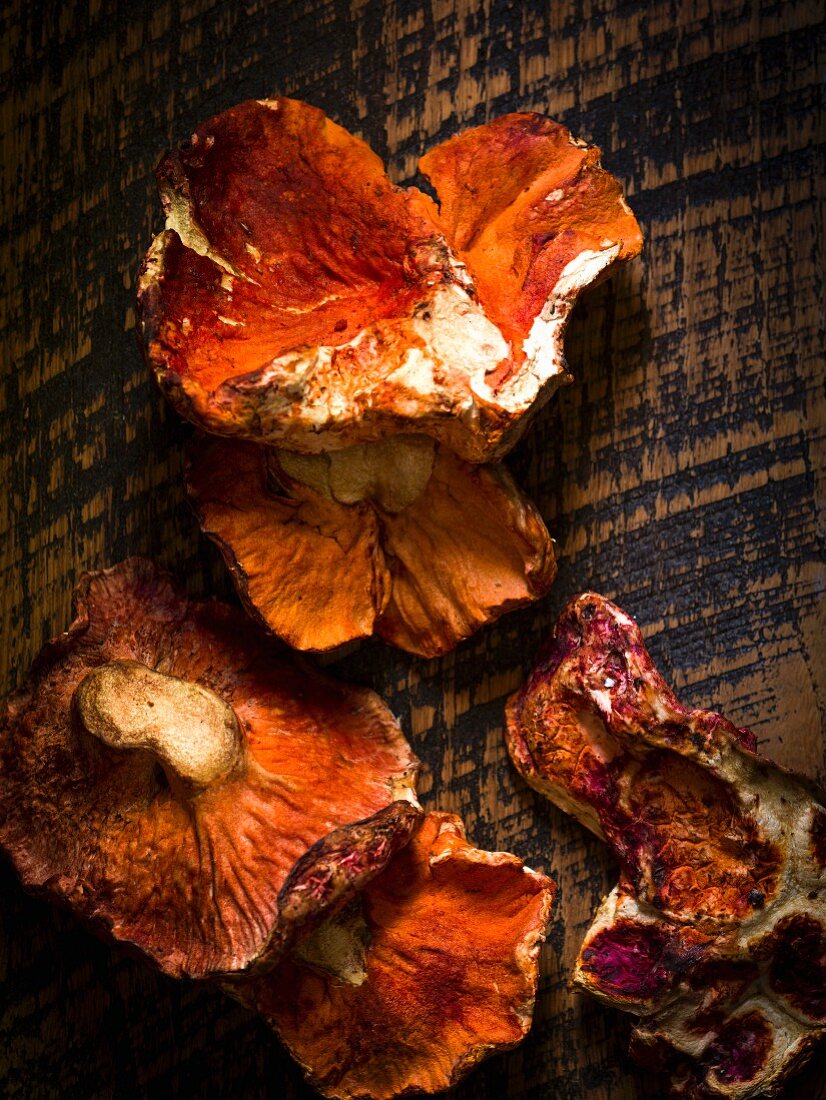 Fresh lobster mushrooms on rustic wood surface
