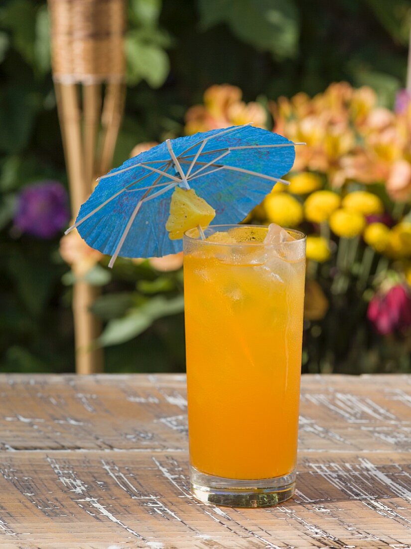 A refreshing fruit cocktail with a pineapple and a paper umbrella