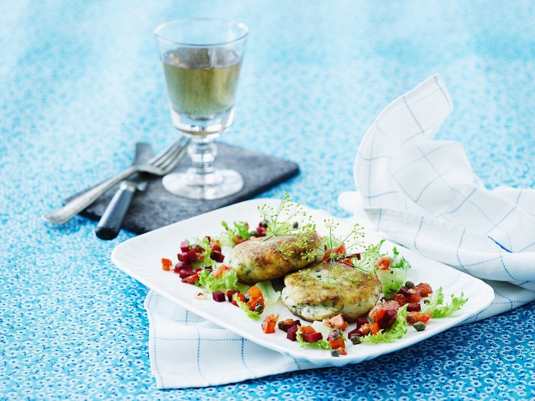 Fish cakes with dill, beetroot, peppers and lettuce
