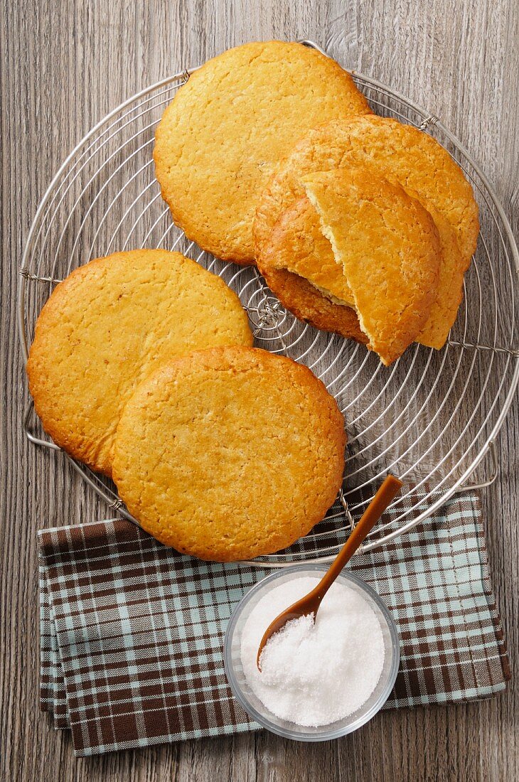 Sables on a wire rack next to a sugar bowl