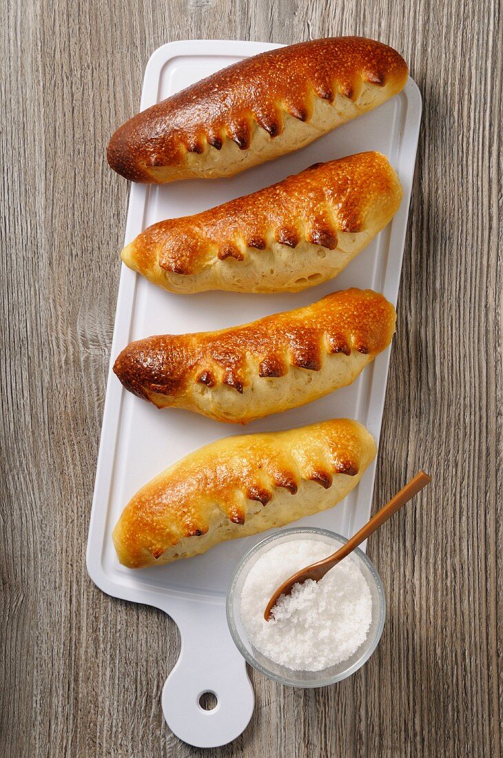 Brioche rolls and sugar on a chopping board