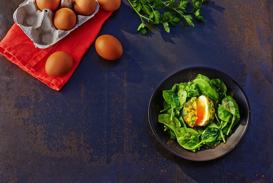 Oeuf en chapelure (bread, fried egg on a bed of spinach, France)