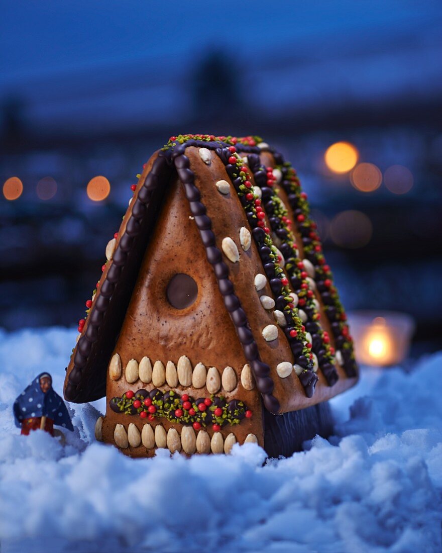 A gingerbread house with a little witch