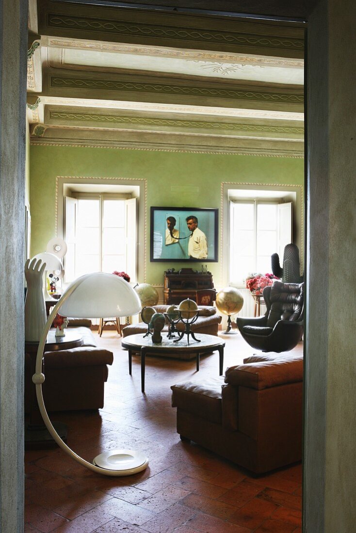 Doorway leading to interior with collection of vintage furnishings and objets d'art in Italian, Renaissance period apartment